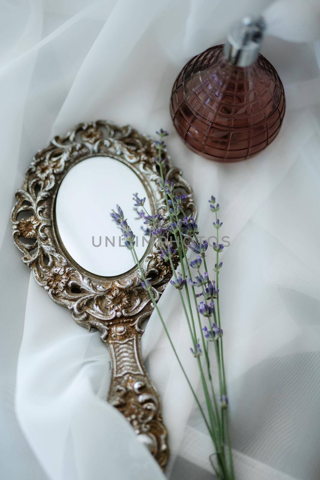 Perfume and a mirror at the morning gathering of the bride