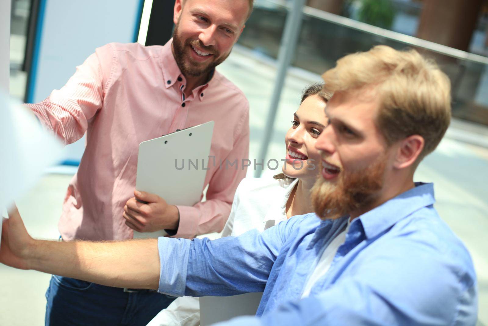 Group of young business people and designers in smart casual wear. They working on new project