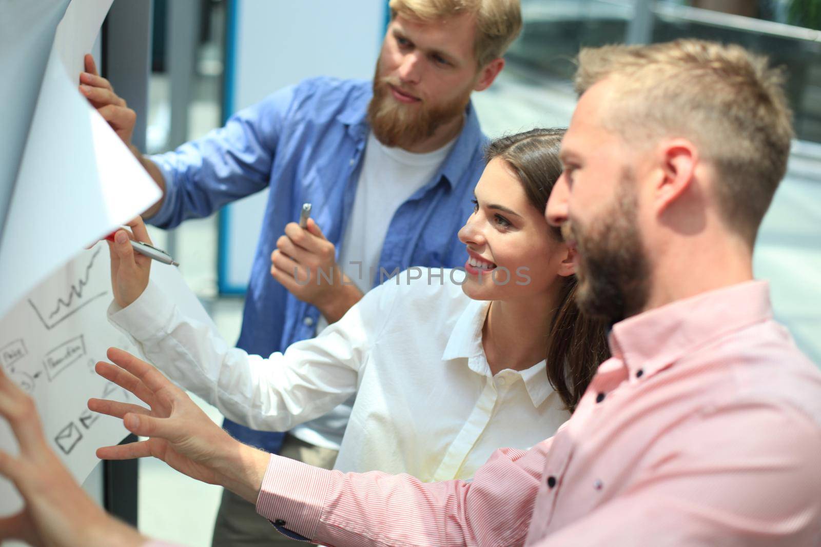 Group of young business people and designers in smart casual wear. They working on new project