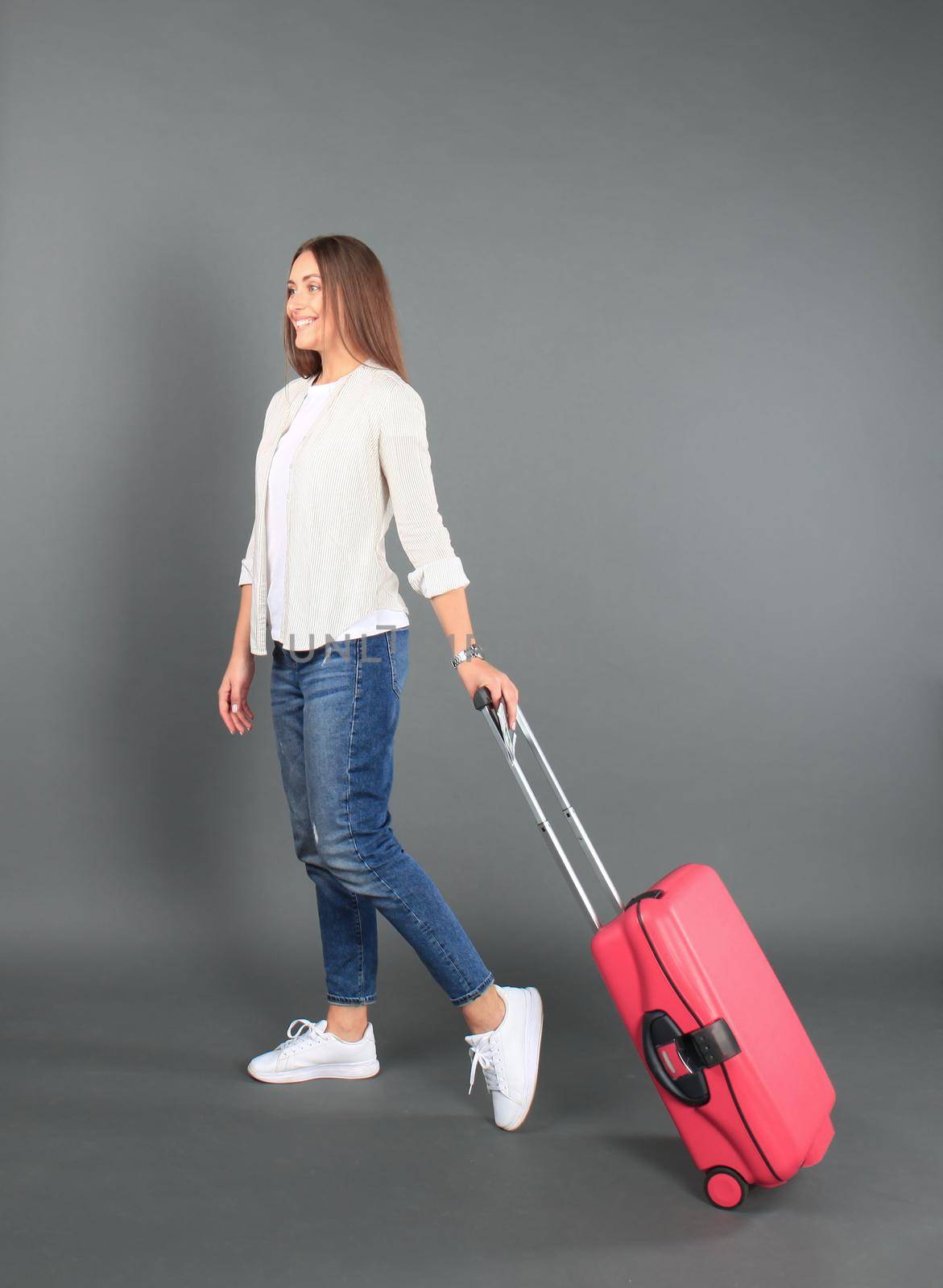 Young tourist girl in summer casual clothes, with sunglasses, red suitcase, passport, tickets isolated grey background. by tsyhun