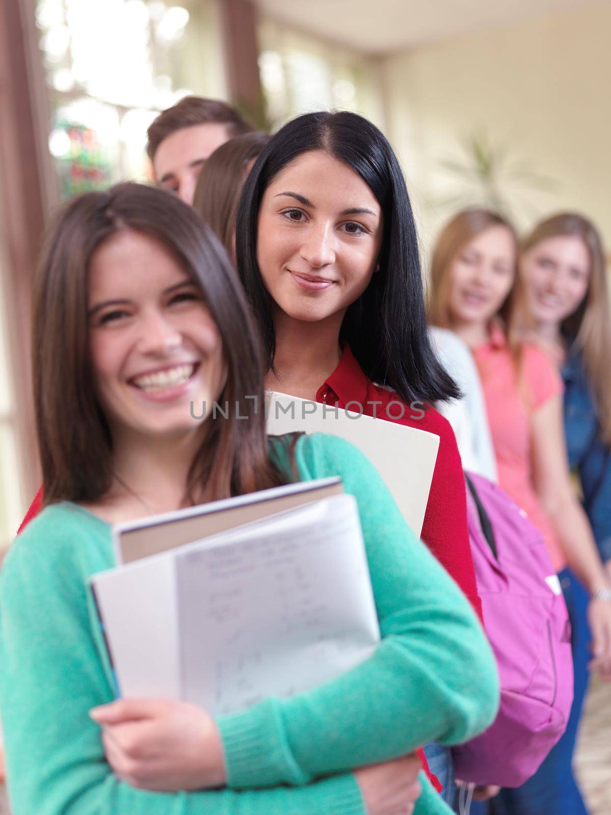 happy young teens group in school on chemisty lessons and library education