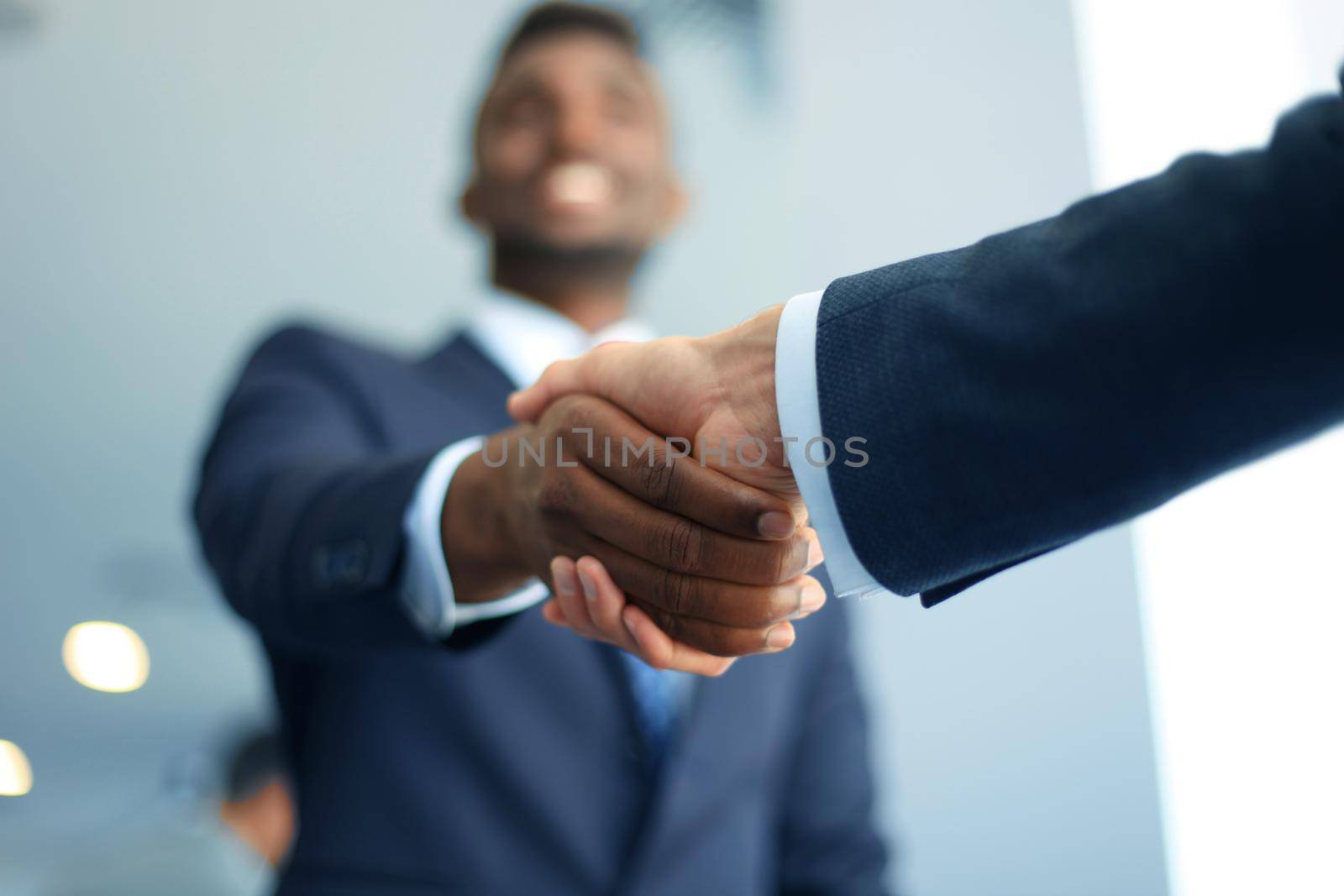 Business people shaking hands, finishing up a meeting by tsyhun