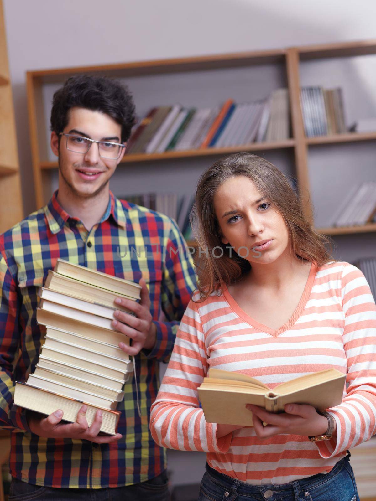 happy young teens group in school on chemisty lessons and library education