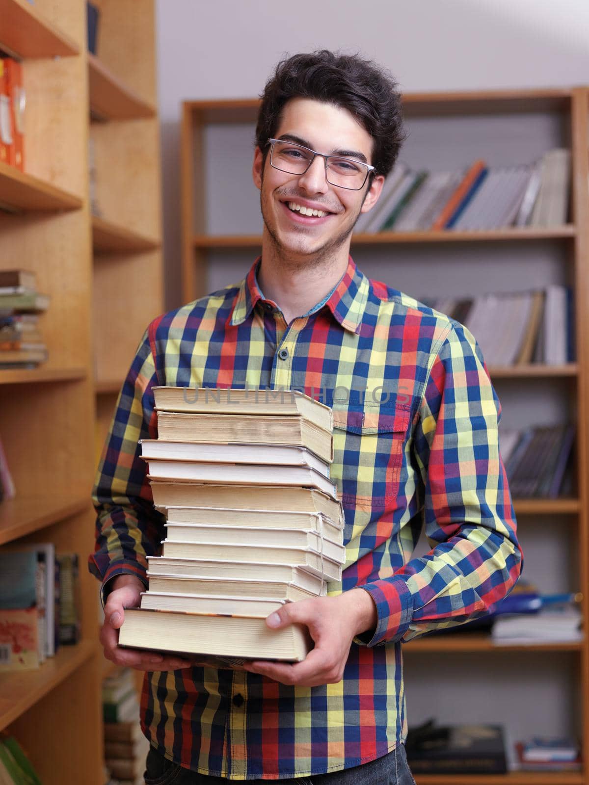 happy young teen boy in school on chemistry classes and library