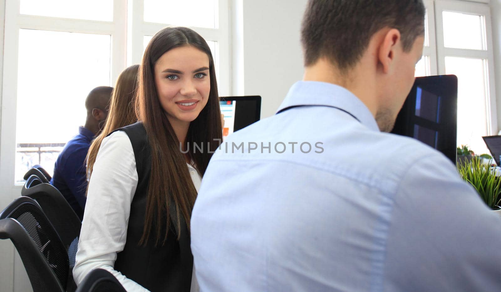 business woman with her staff, people group in background at modern bright office indoors