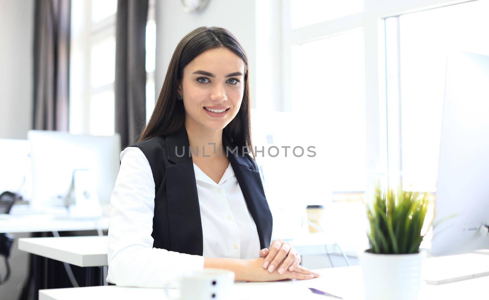 Modern business woman in the office with copy space by tsyhun