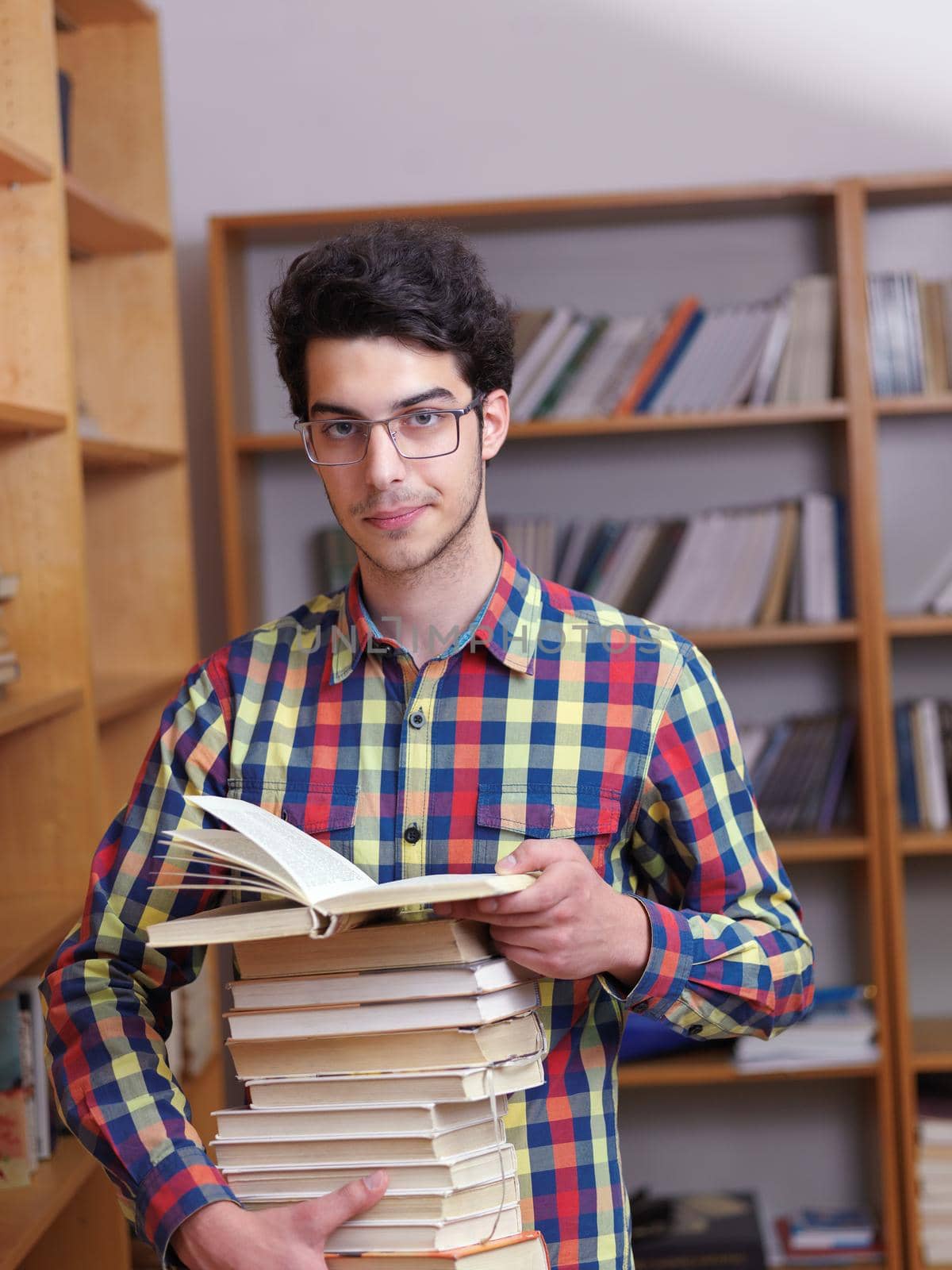 happy young teen boy in school on chemistry classes and library