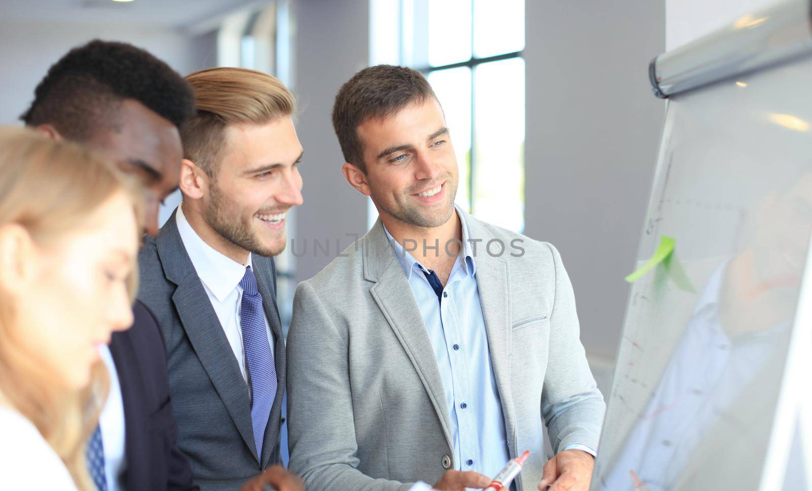 Business people team at presentation working with charts and diargams at flipchart.