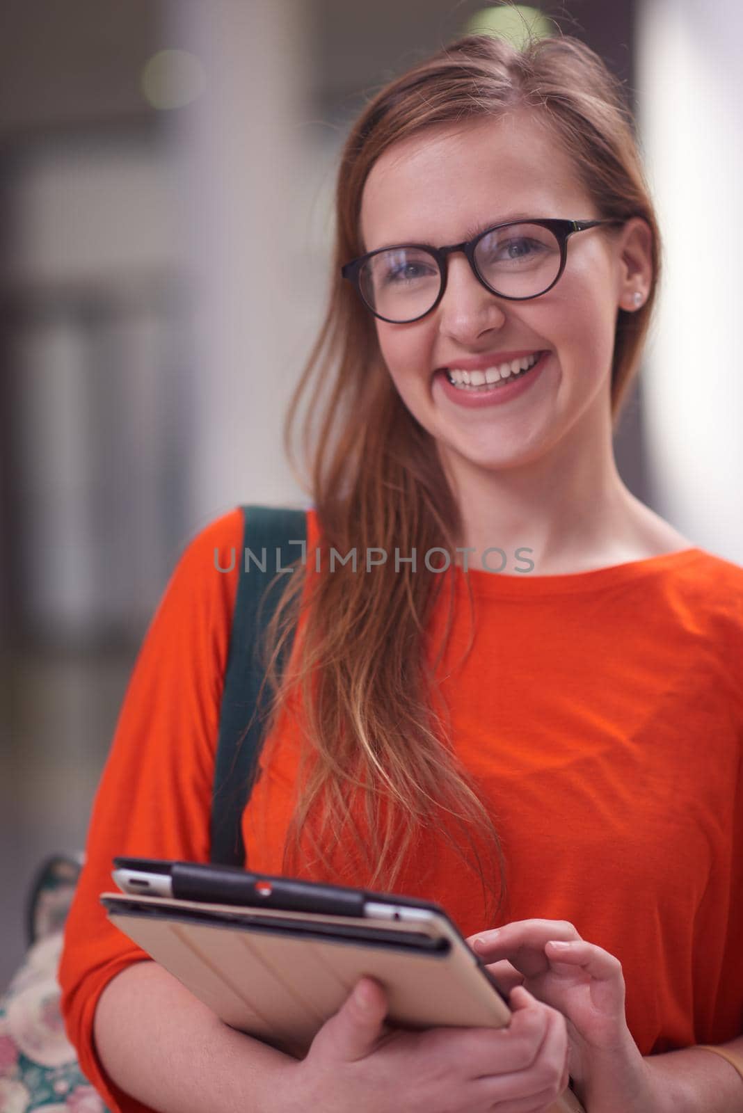 happy student girl working on tablet computer at modern school university indoors