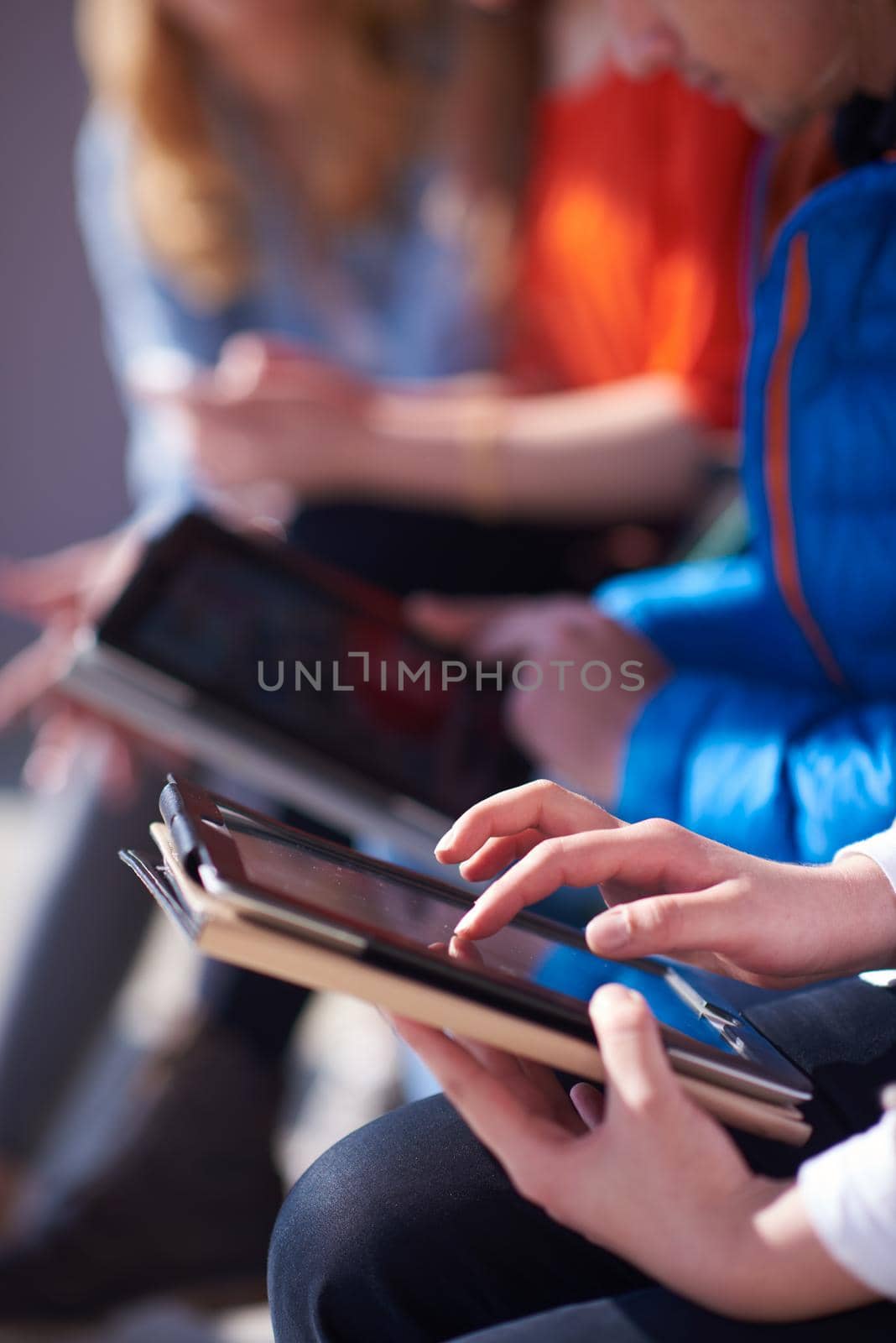 students group working on school  project  together on tablet computer  at modern university