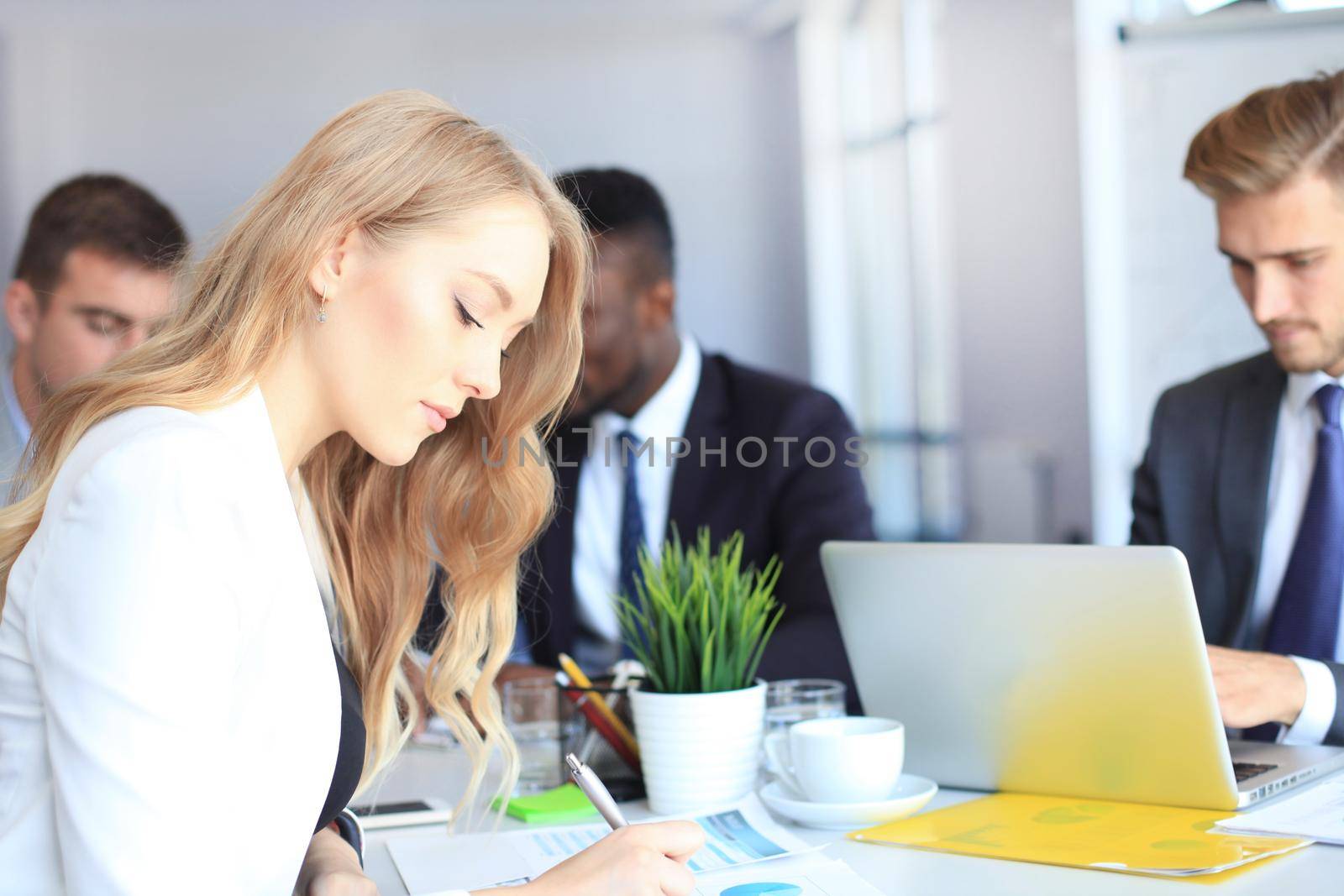 business woman with her staff, people group in background at modern bright office indoors