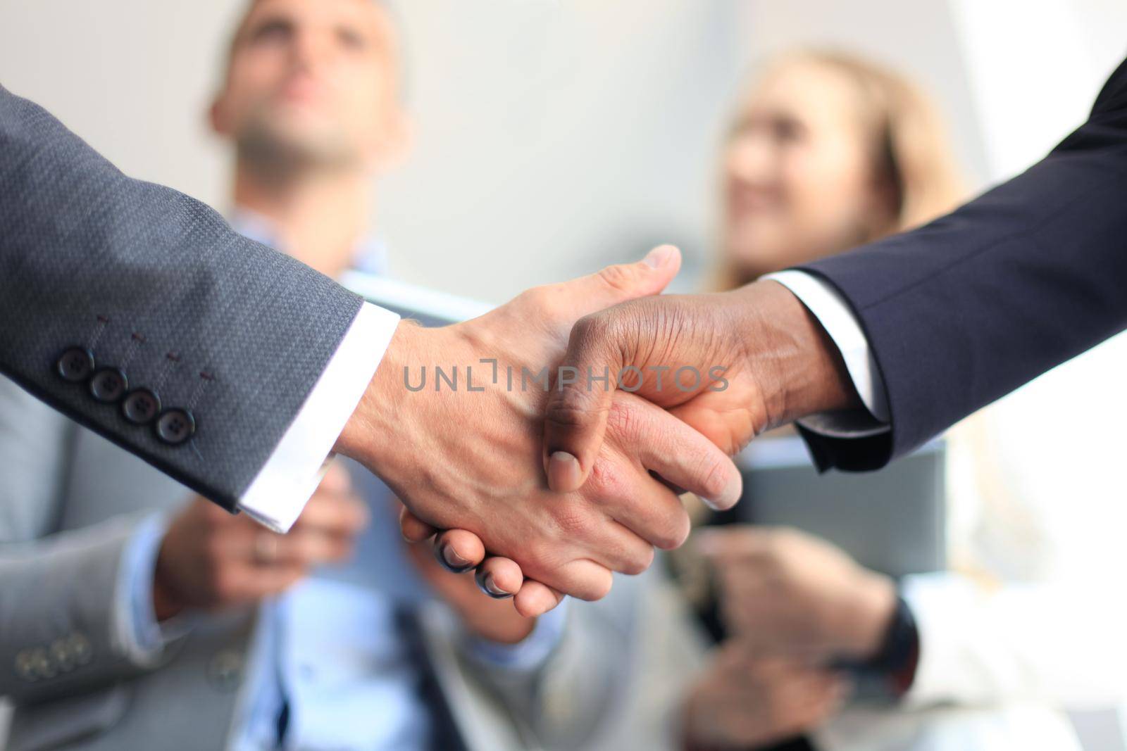 Business people shaking hands, finishing up a meeting by tsyhun