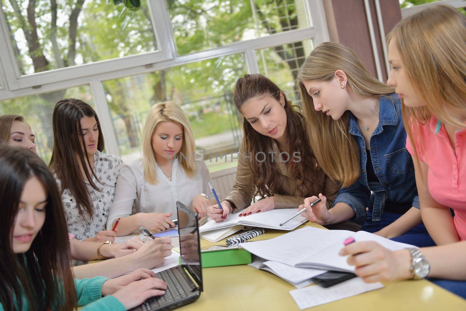 happy young teens group in school on chemisty lessons and library education