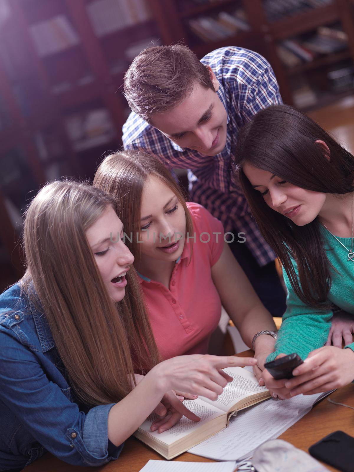 happy young teens group in school on chemisty lessons and library education