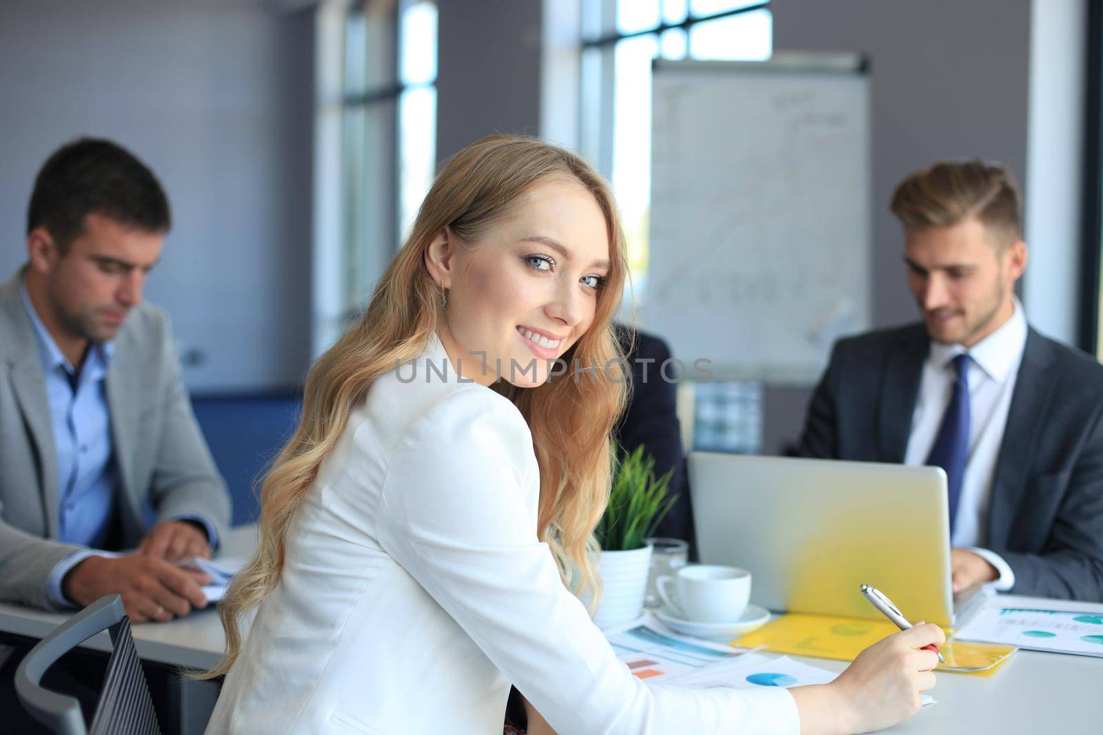 business woman with her staff, people group in background at modern bright office indoors