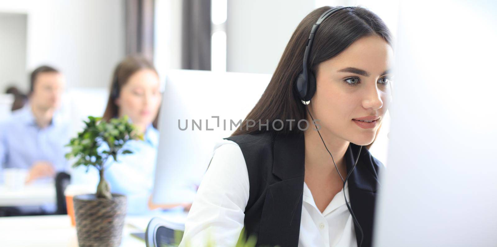 Attractive positive young businesspeople and colleagues in a call center office by tsyhun