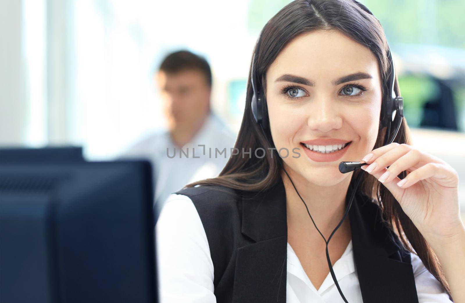 Businesswoman wearing microphone headset using computer in the office - operator, call center. by tsyhun