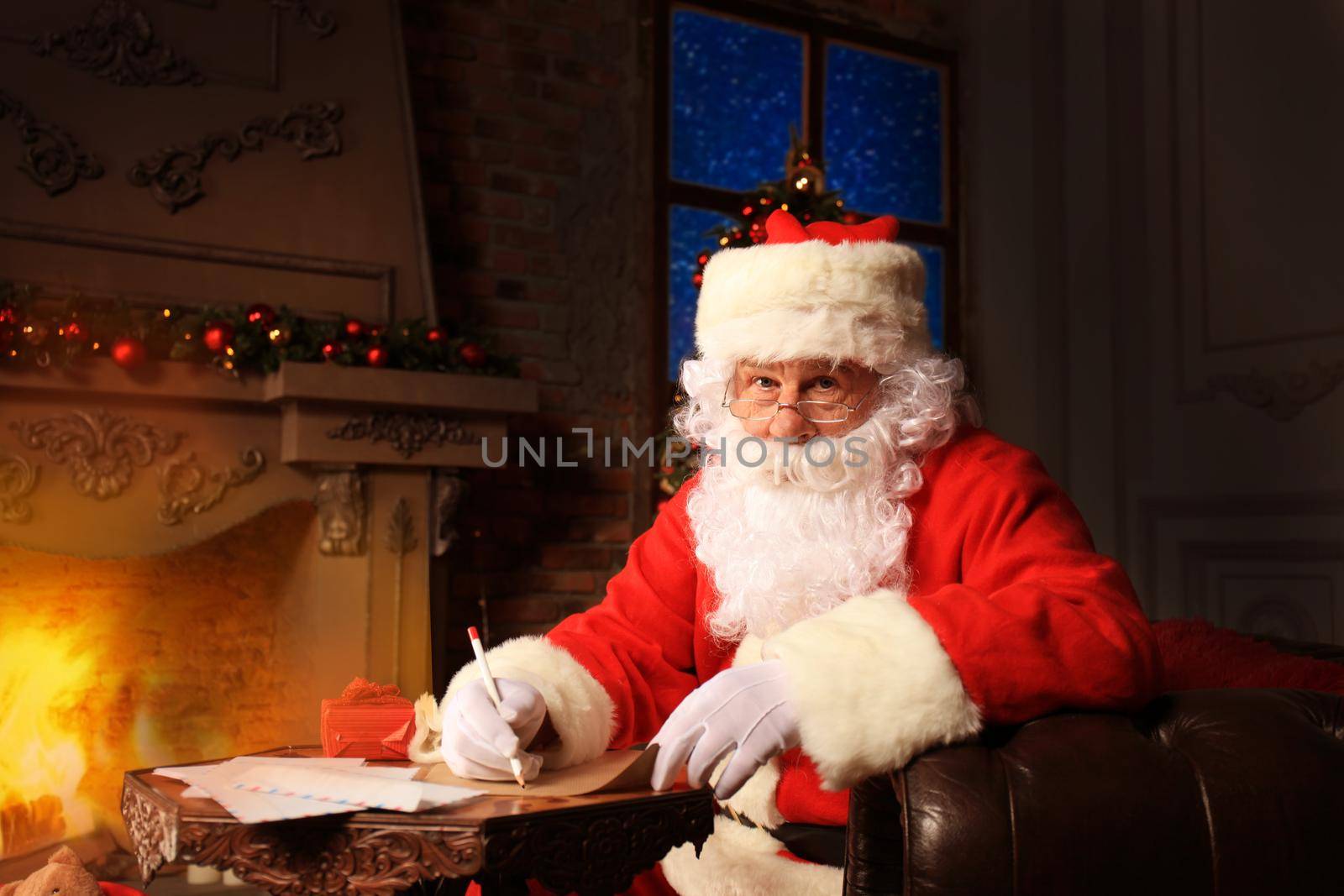 Portrait of Santa Claus answering Christmas letters.