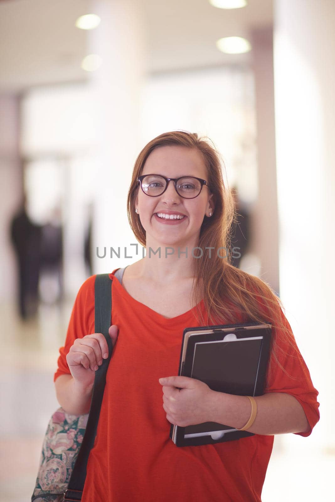 happy student girl working on tablet computer at modern school university indoors
