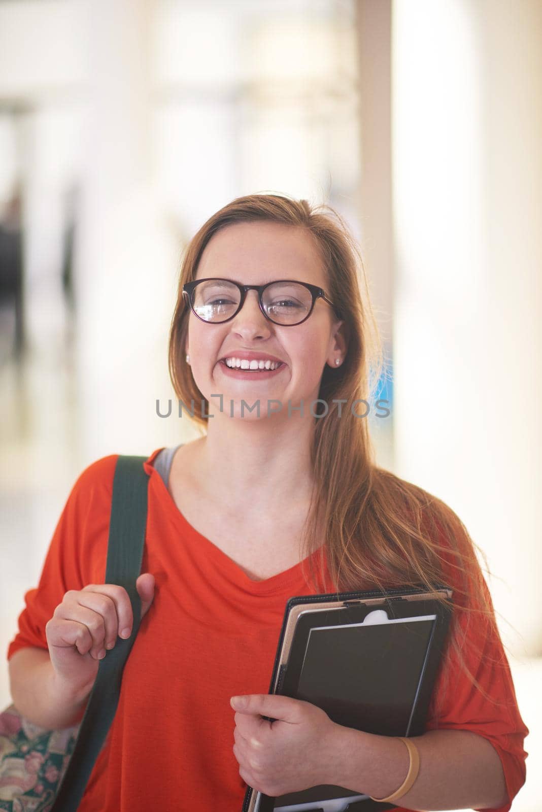 happy student girl working on tablet computer at modern school university indoors