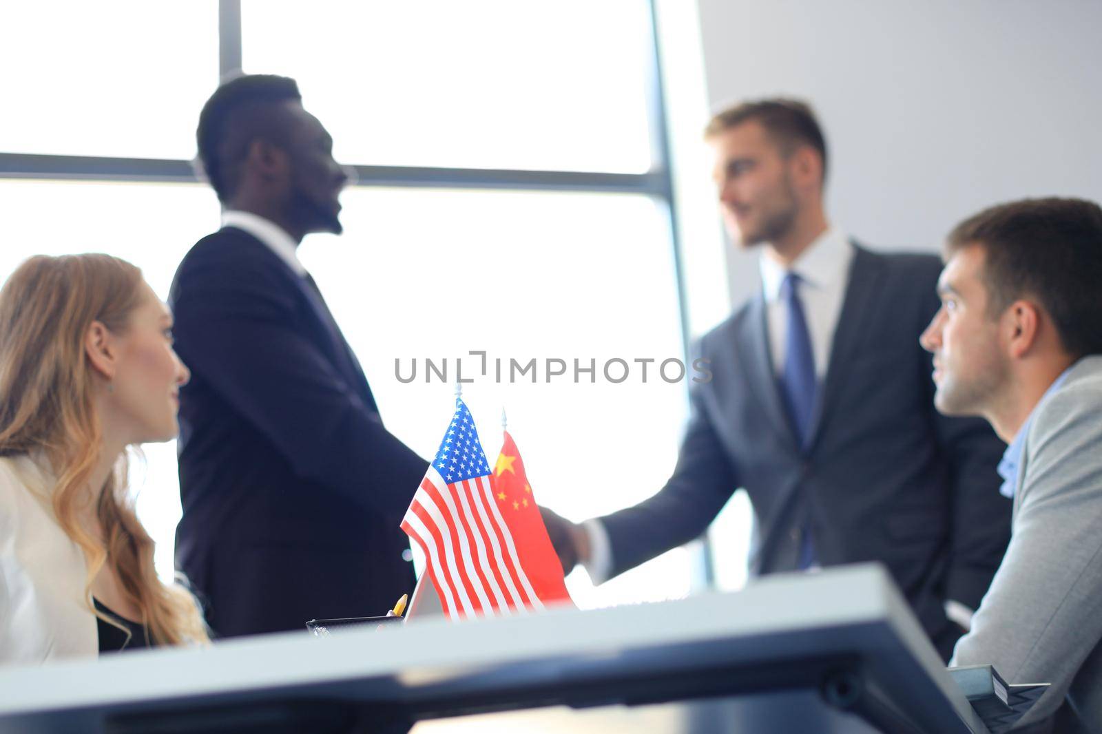 Chinese and American leaders shaking hands on a deal agreement.