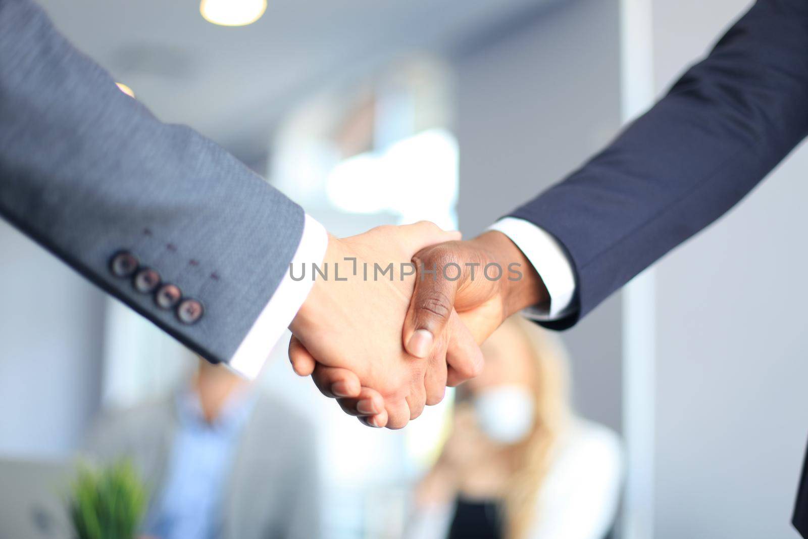 Business people shaking hands, finishing up a meeting by tsyhun