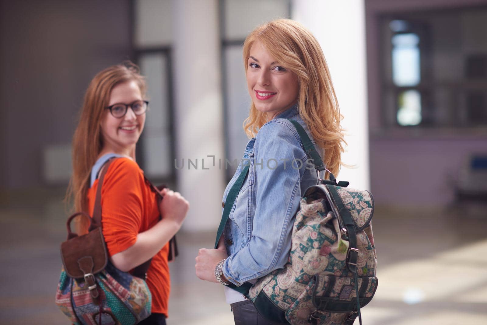 friends together at school, two student girls with backpack and tablet on university