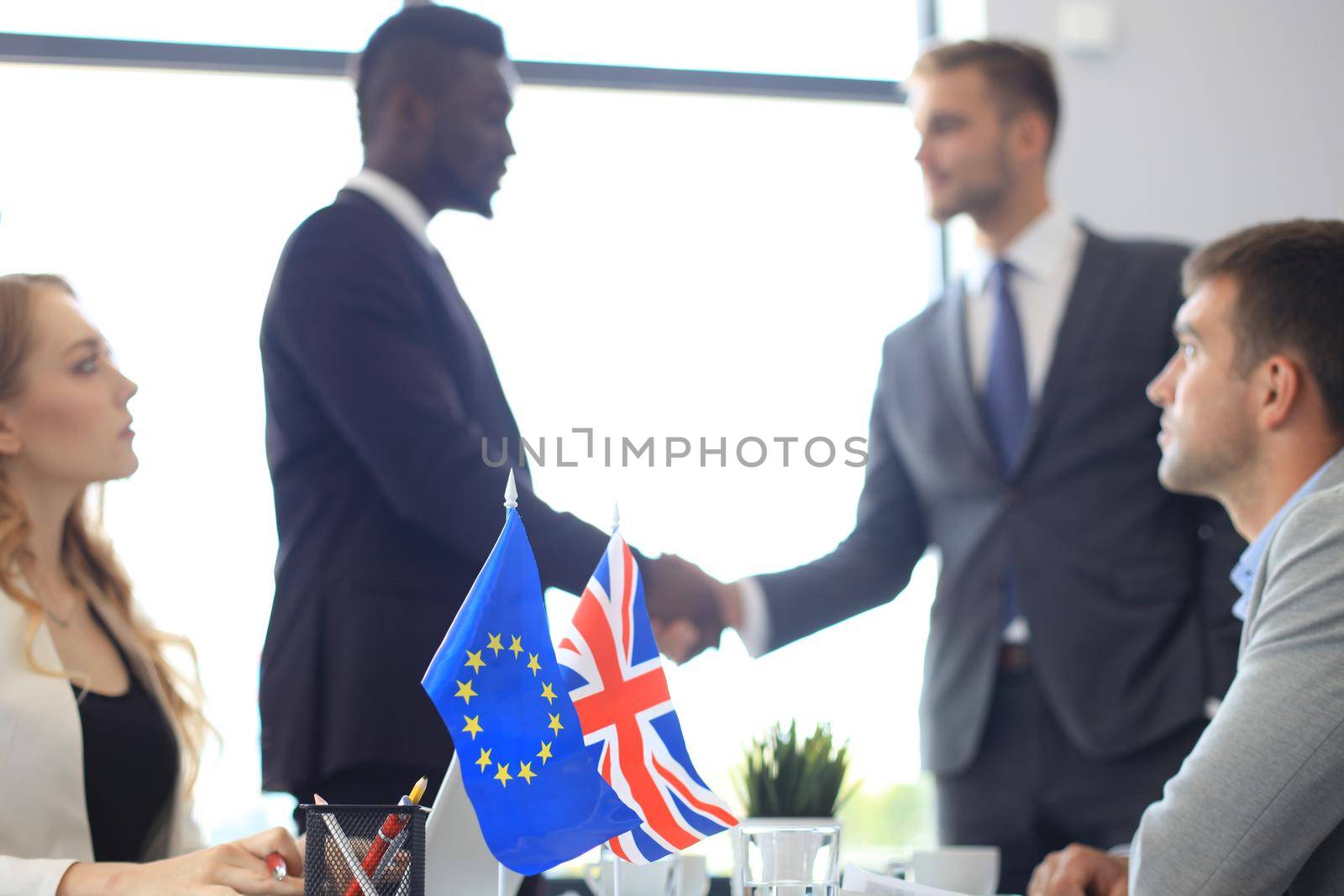 European Union and United Kingdom leaders shaking hands on a deal agreement. Brexit