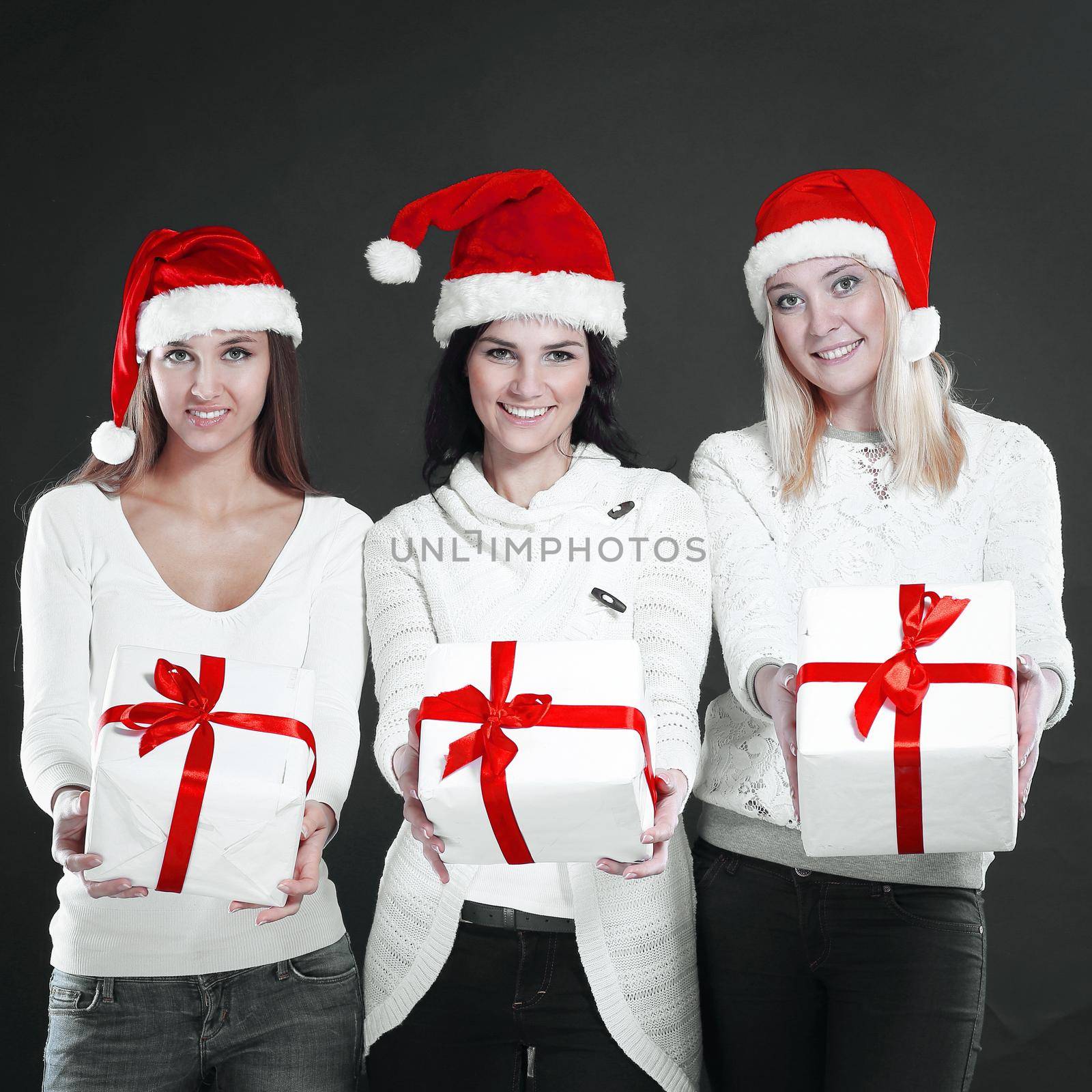 three young women in costume of Santa Claus with Christmas shopping.photo with copy space.