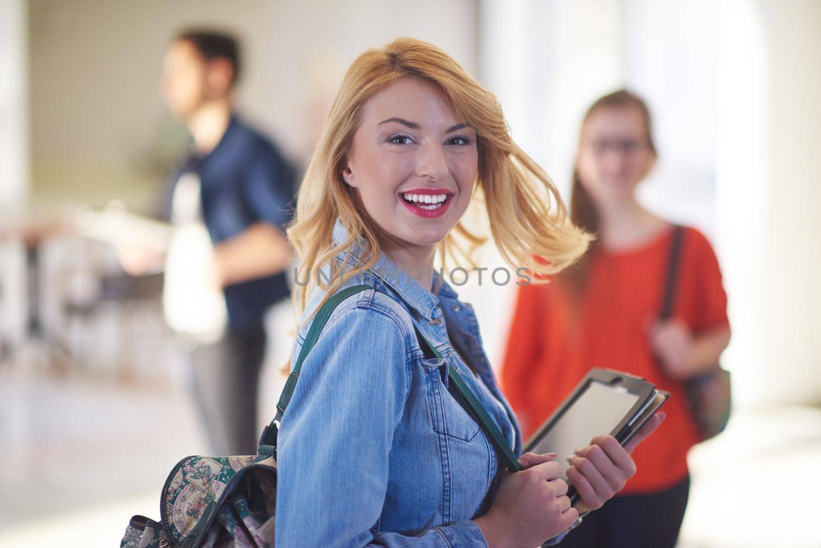 happy student girl working on tablet computer at modern school university indoors