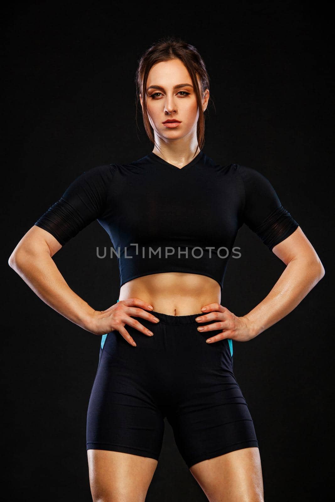 Sporty fit woman, athlete make fitness exercises on black background. by MikeOrlov