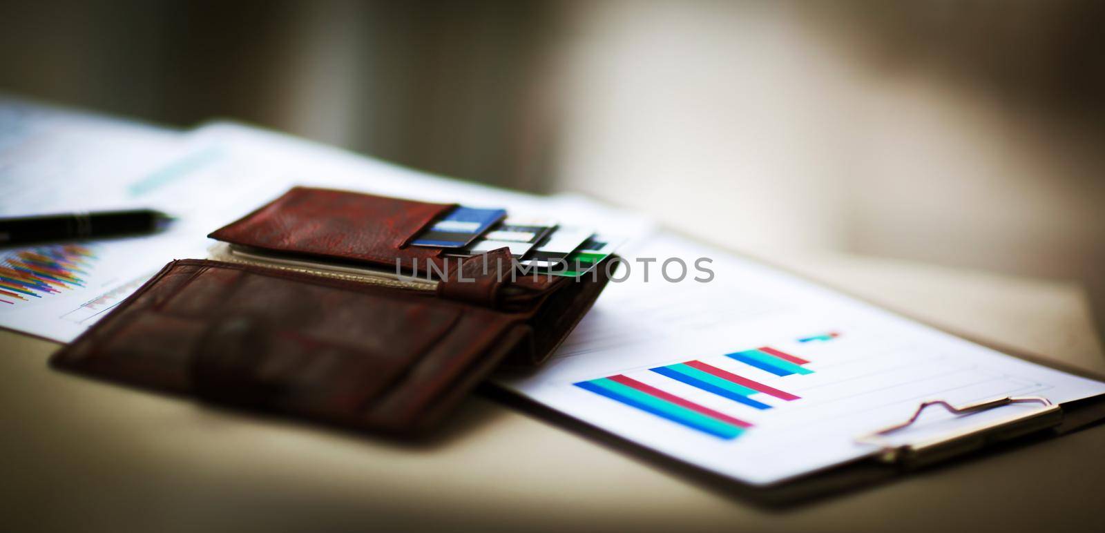 financial charts and graphs in the table. Workplace in office