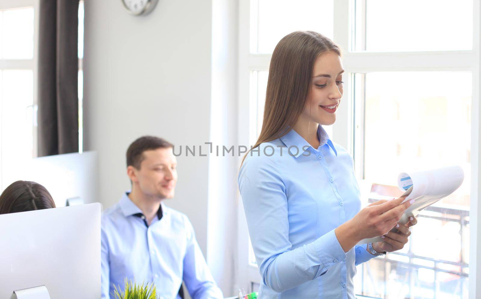 business woman with her staff, people group in background at modern bright office indoors