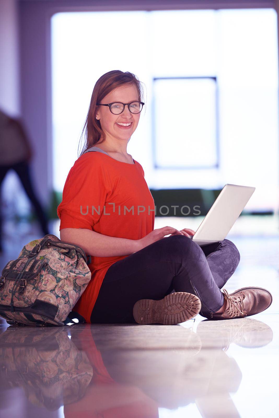 happy student girl working on laptop computer at modern school university indoors