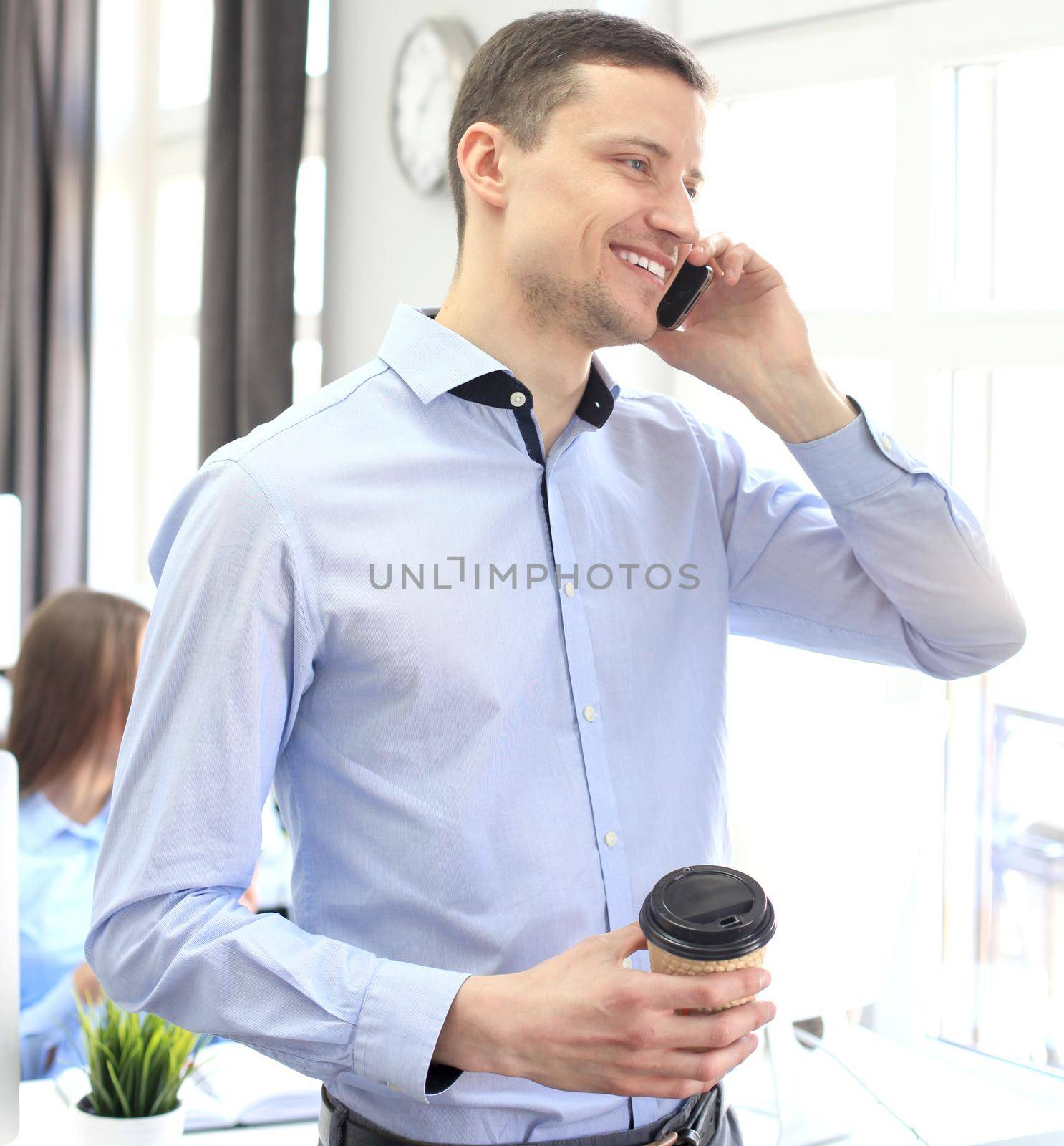 Businessman talk to cellphone and look out of window