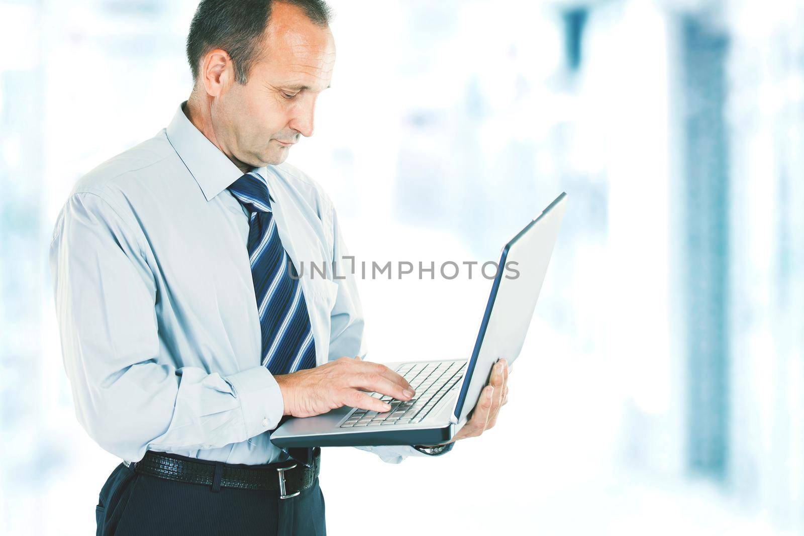 close-up of a businessman who deals on the Internet on the laptop. photo blurred background and has an empty space for your text