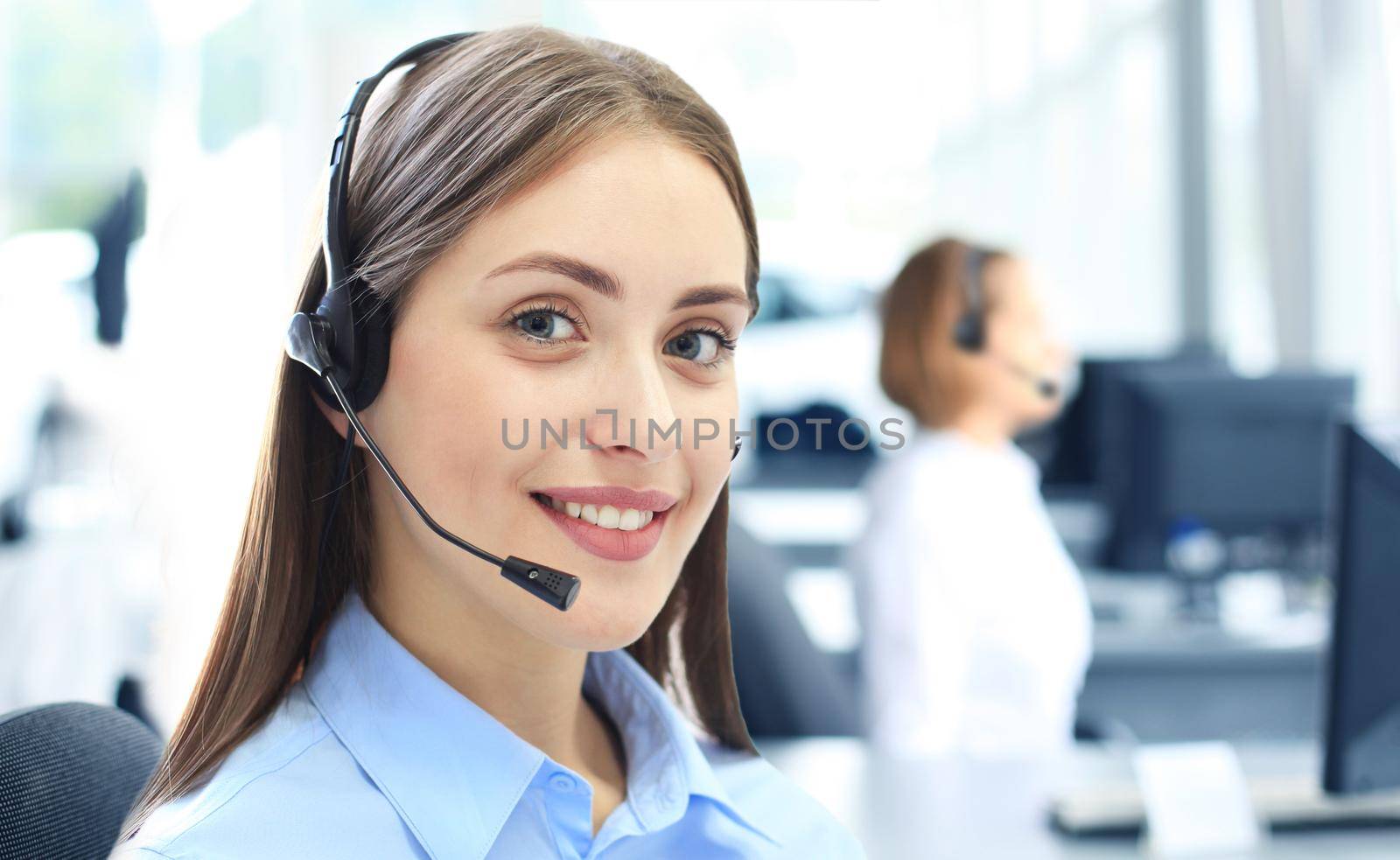 Attractive positive young businesspeople and colleagues in a call center office by tsyhun
