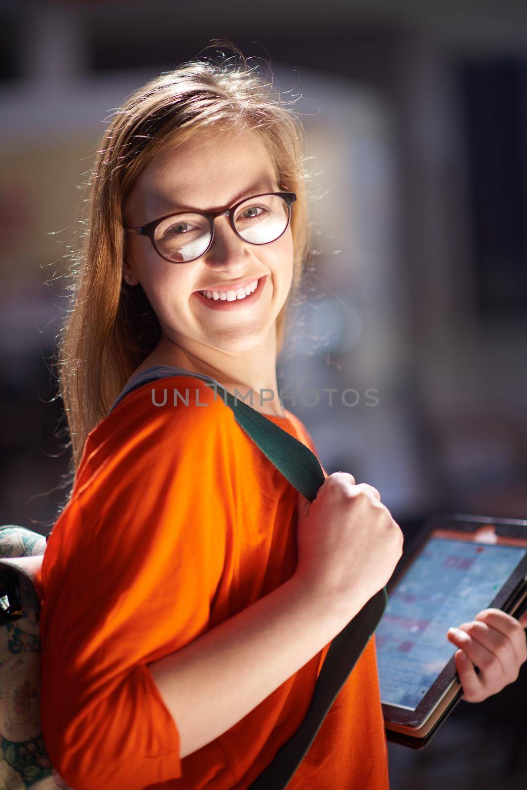 happy student girl working on tablet computer at modern school university indoors