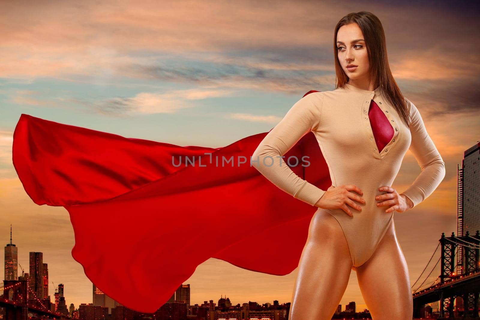 Woman super hero. Sporty fit woman, athlete posing on city background. by MikeOrlov