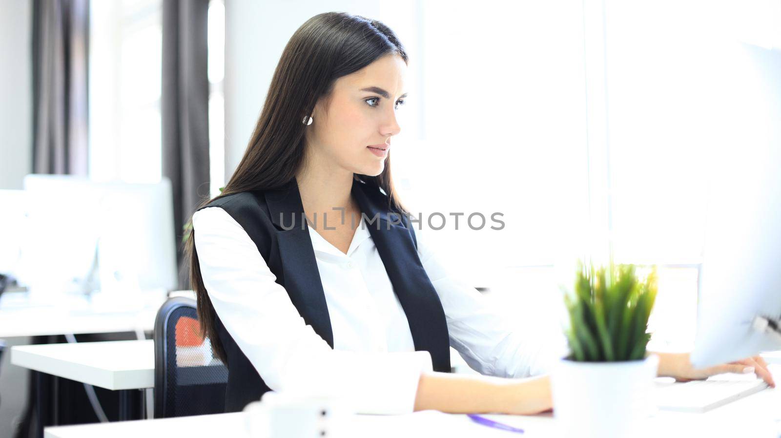 Modern business woman in the office with copy space by tsyhun