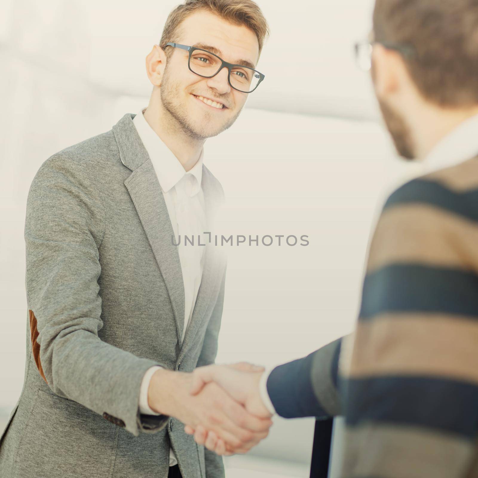 concept of a reliable partnership - the lawyer and the client, shake hands after signing the financing contract by SmartPhotoLab