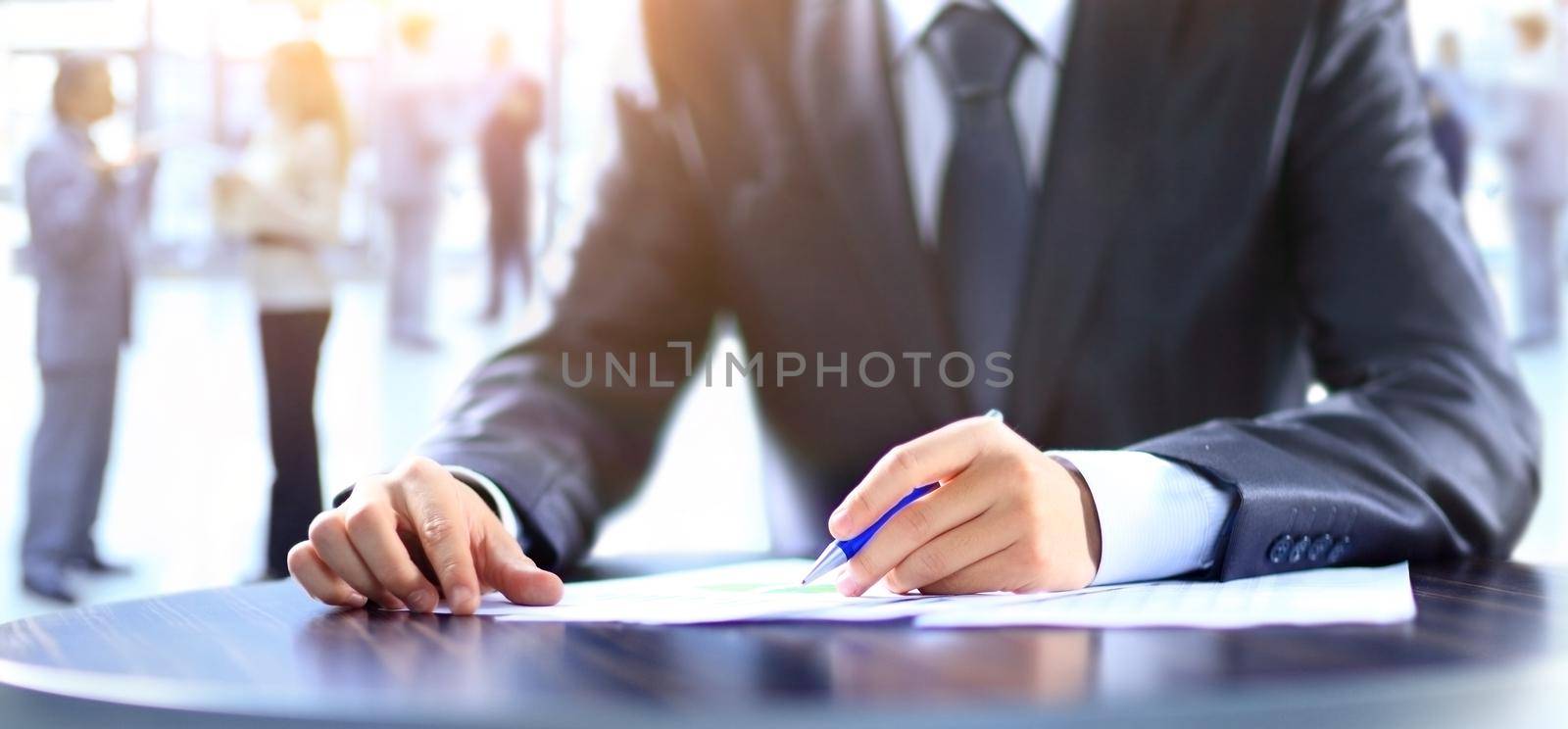 close up. businessman with a pen reading a business document.business concept