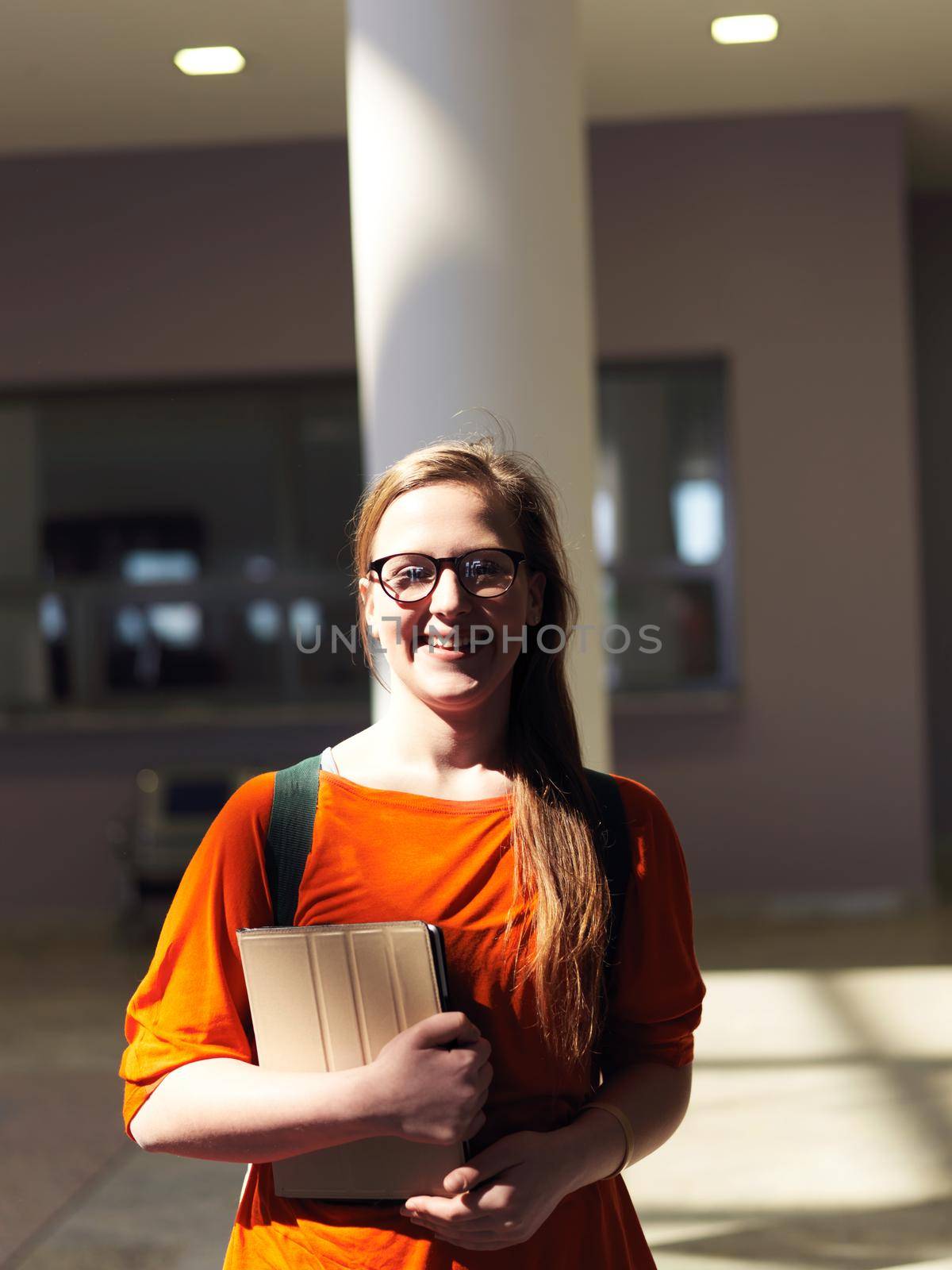 happy student girl working on tablet computer at modern school university indoors