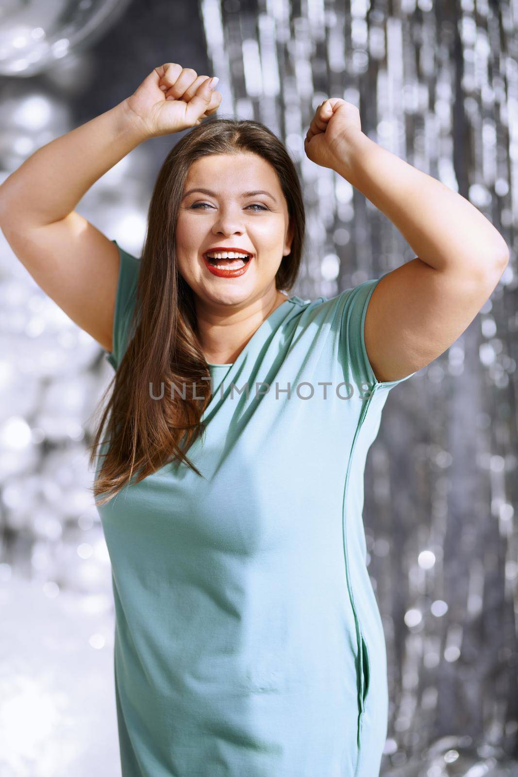 Portrait of the happy successful plus size woman