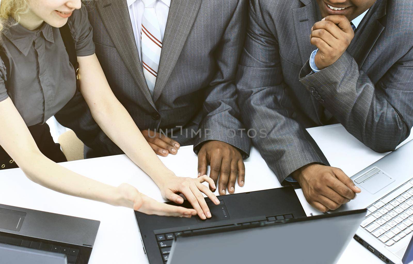 close up.Interracial business team working at laptop in a modern office