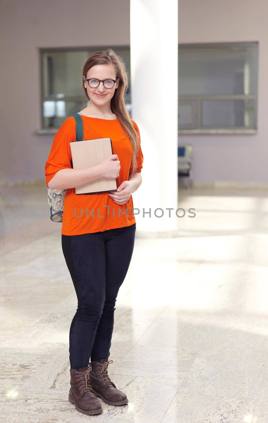 happy student girl working on tablet computer at modern school university indoors