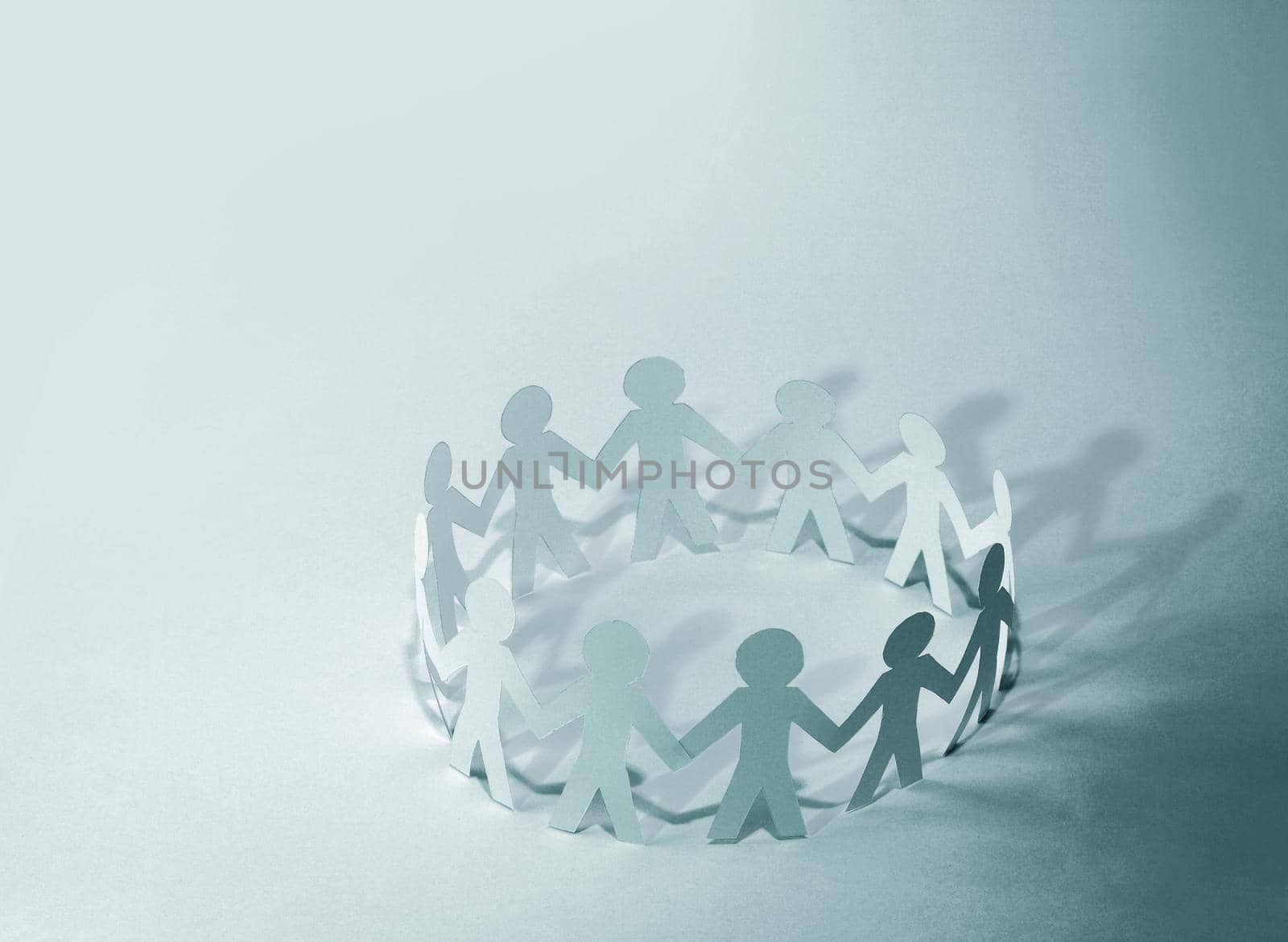 Team of paper doll people holding hands by SmartPhotoLab