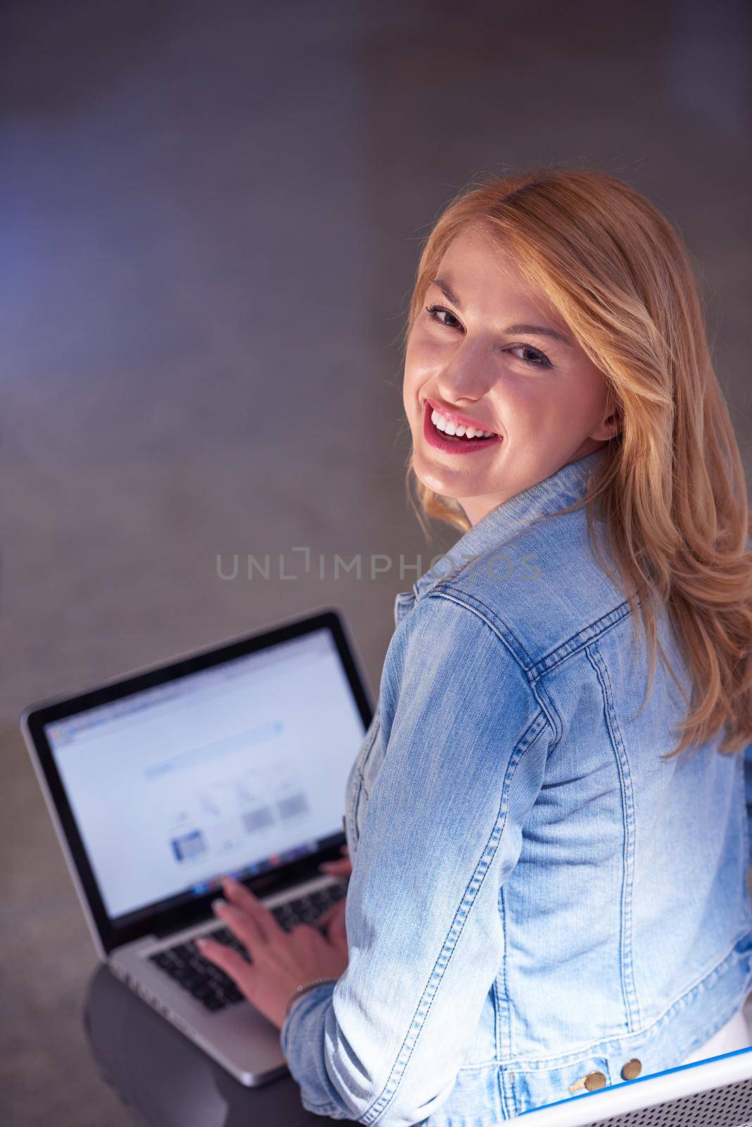 happy student girl working on laptop computer at modern school university indoors