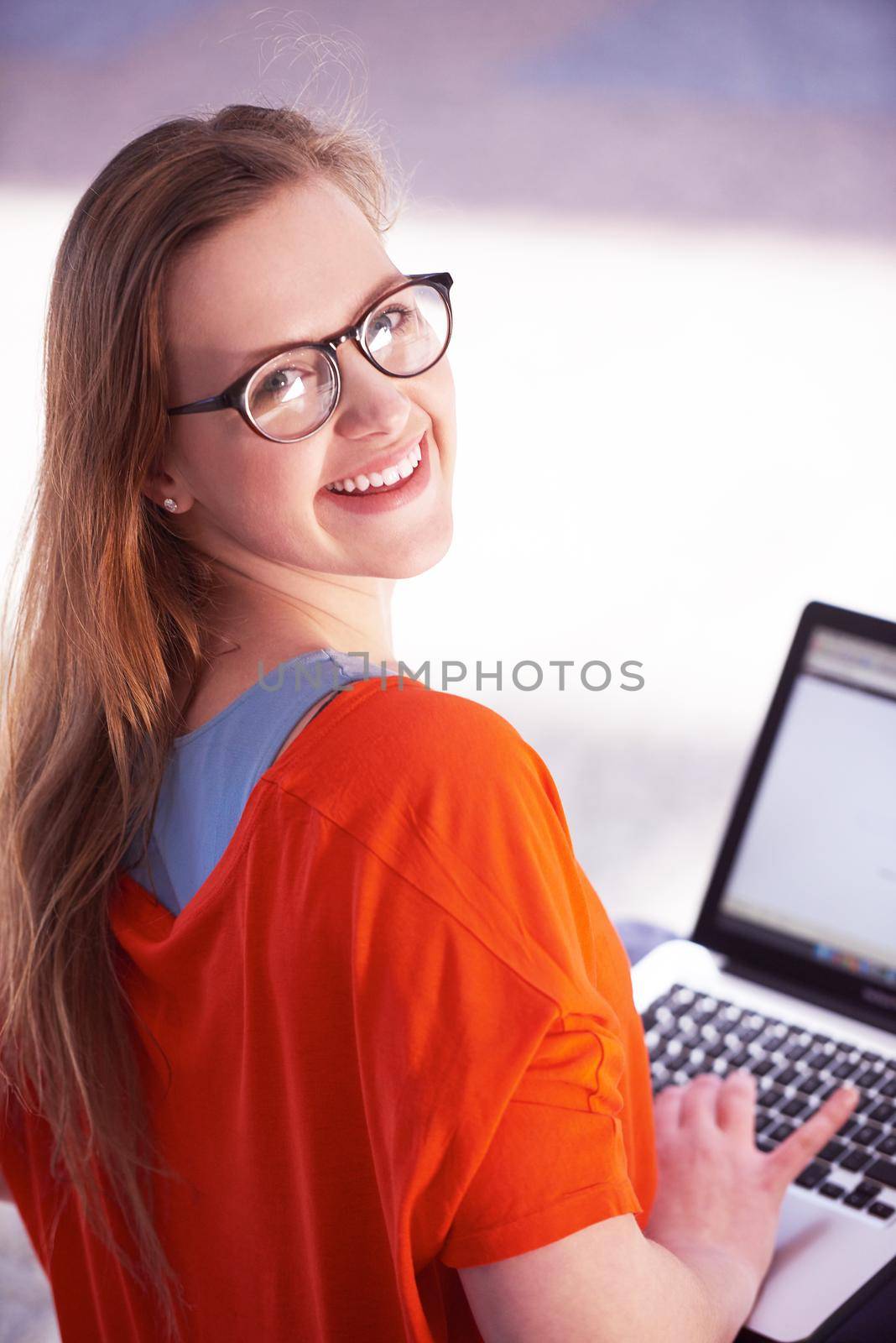 happy student girl working on laptop computer at modern school university indoors