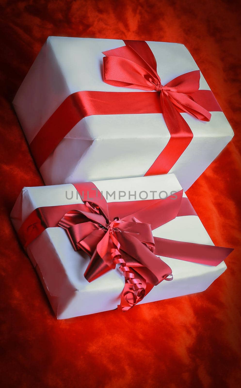 closeup. two elegant gift boxes.isolated on red by SmartPhotoLab